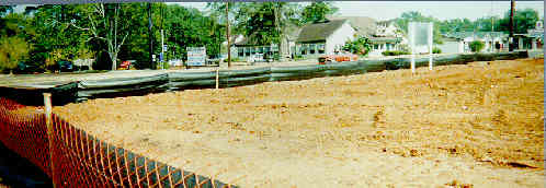 Woven Geotextile silt fence reenforced with safty fence attached to wood stakes